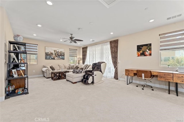 carpeted living room featuring ceiling fan