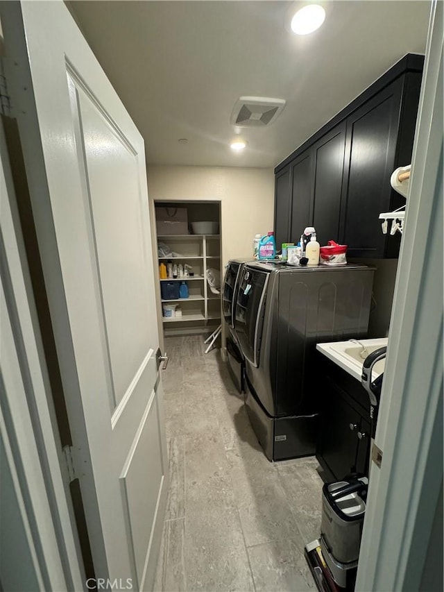 laundry area featuring cabinets and independent washer and dryer