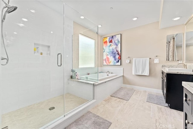 bathroom with vanity and independent shower and bath