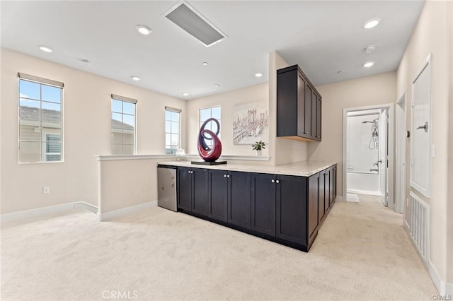 kitchen featuring light colored carpet, dishwasher, and a wealth of natural light