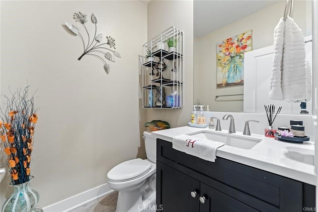 bathroom with toilet, tile patterned floors, and vanity