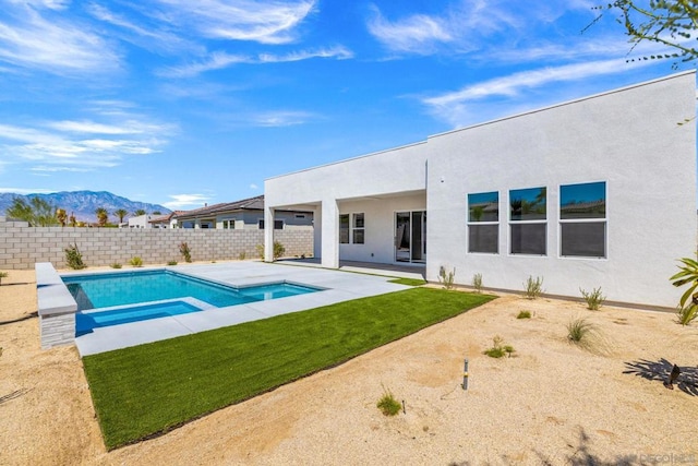 view of pool featuring a patio area, a mountain view, and a yard