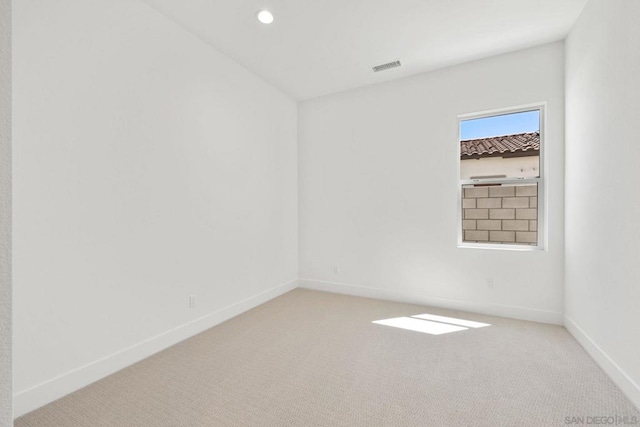 unfurnished room featuring light carpet