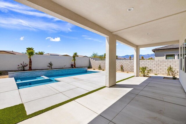 view of pool with a patio area and a mountain view