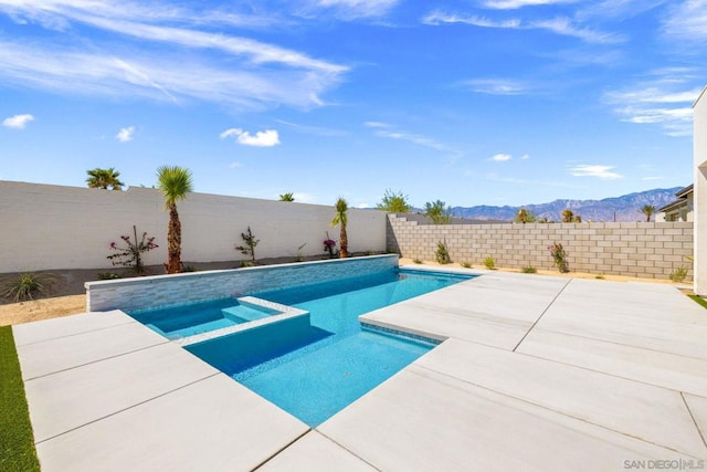 view of swimming pool featuring a mountain view and an in ground hot tub