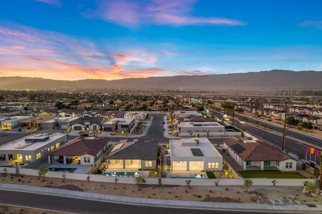 aerial view at dusk featuring a mountain view