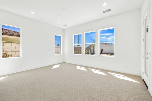 unfurnished room featuring light colored carpet