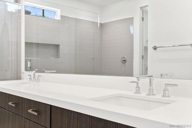 bathroom featuring vanity and a shower