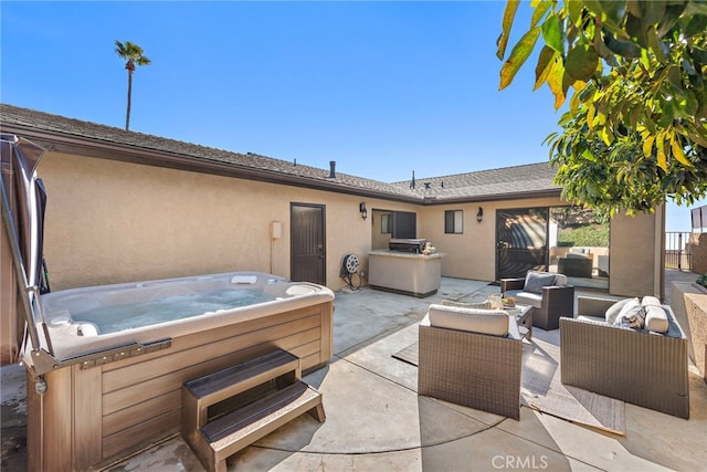 view of patio / terrace featuring a hot tub and an outdoor living space