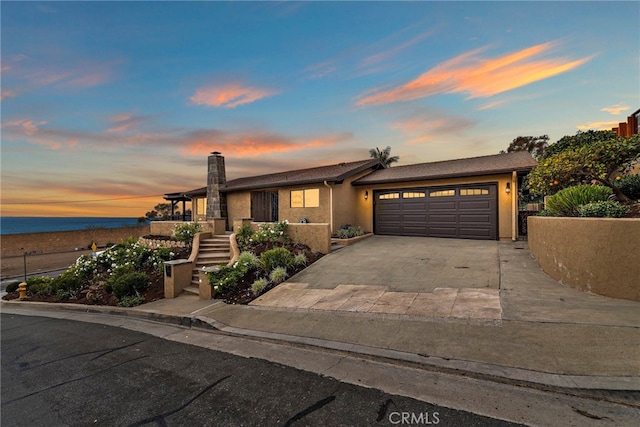 view of front of home featuring a water view and a garage