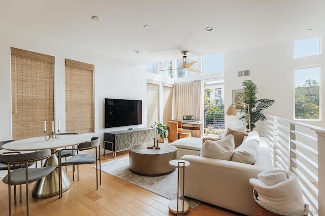 living room featuring ceiling fan and hardwood / wood-style flooring