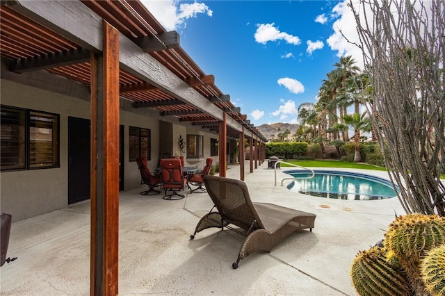 view of swimming pool with a mountain view, a patio, and a pergola