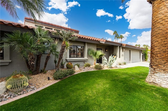 view of front of house featuring a garage and a front yard