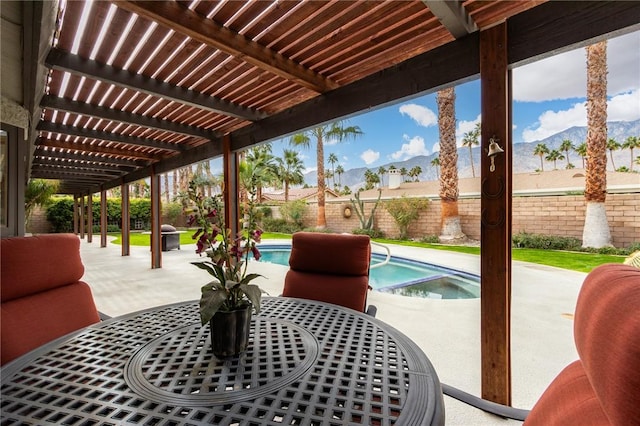 view of patio with a mountain view, a fenced in pool, and a pergola