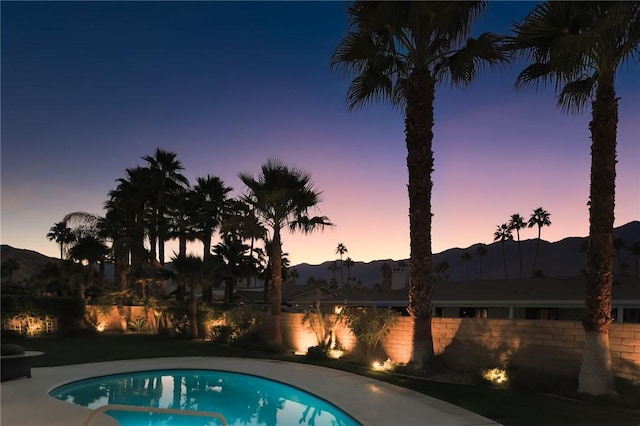 pool at dusk with a mountain view