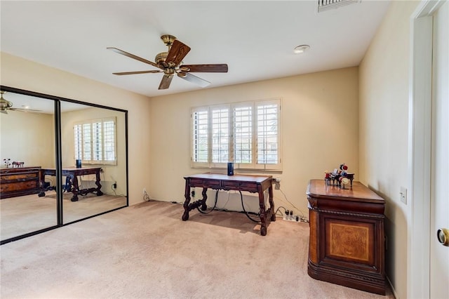 misc room with ceiling fan and light colored carpet