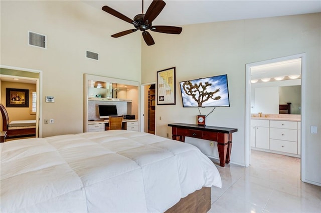 bedroom with ceiling fan, ensuite bath, light tile patterned flooring, high vaulted ceiling, and sink