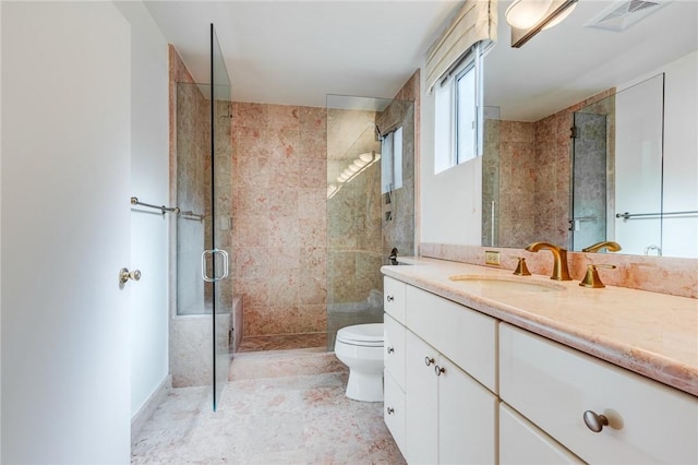 bathroom with toilet, a shower with shower door, and vanity