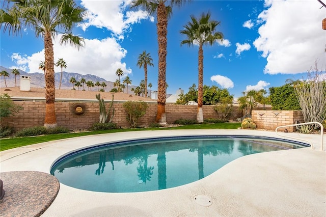 view of swimming pool featuring a mountain view