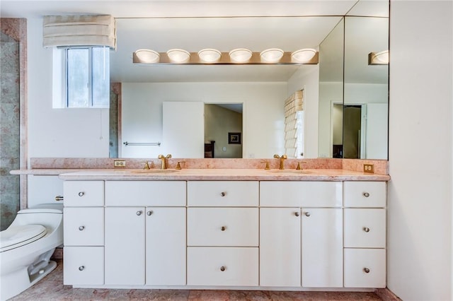 bathroom featuring toilet and vanity