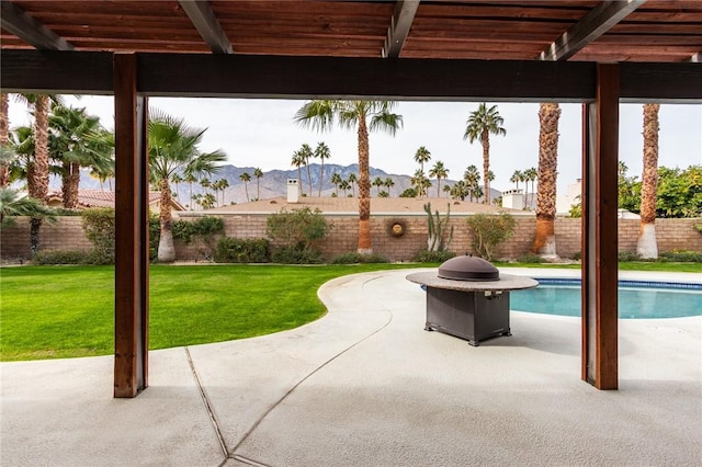 view of patio / terrace featuring a mountain view and a fenced in pool