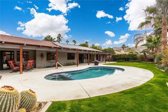 view of swimming pool with a patio area and a yard