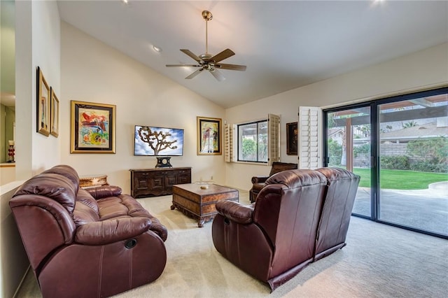 living room featuring ceiling fan, vaulted ceiling, and light carpet