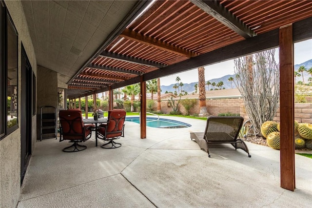 view of patio / terrace featuring a mountain view, a fenced in pool, and a pergola