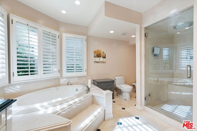 bathroom featuring toilet, separate shower and tub, and tile patterned flooring