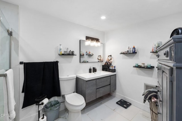 bathroom featuring toilet, vanity, and tile patterned flooring