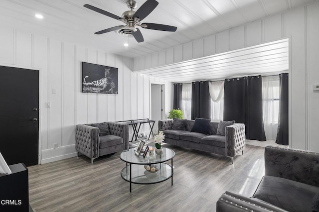 living room with ceiling fan and wood-type flooring