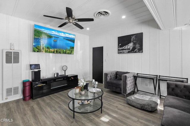 living room featuring ceiling fan and wood-type flooring