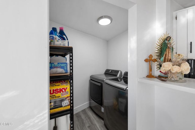 washroom featuring light hardwood / wood-style floors and washing machine and dryer