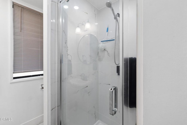 bathroom featuring a shower with shower door