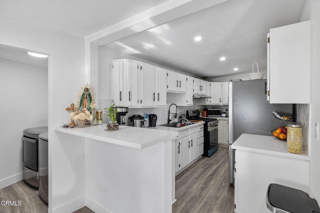 kitchen featuring white cabinetry, kitchen peninsula, stainless steel range with gas stovetop, backsplash, and sink