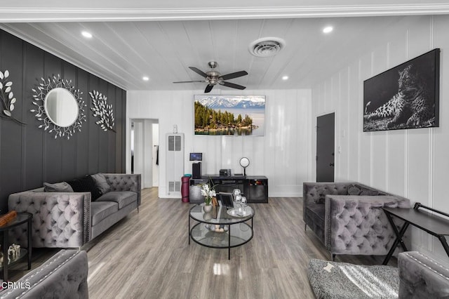 living room featuring ceiling fan and hardwood / wood-style floors