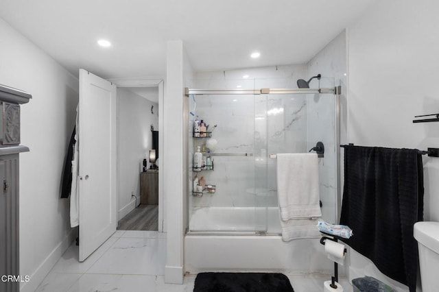 bathroom with enclosed tub / shower combo and toilet