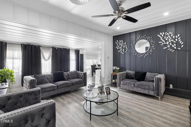 living room featuring ceiling fan and hardwood / wood-style flooring