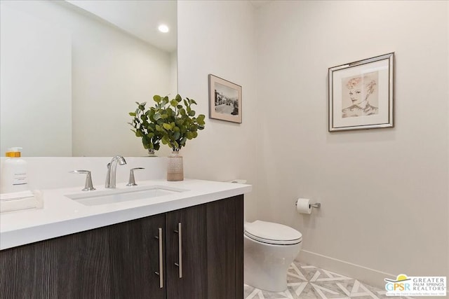 bathroom with toilet and vanity