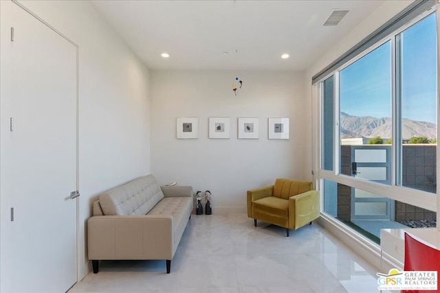 sitting room with a healthy amount of sunlight and a mountain view