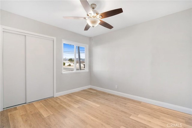 unfurnished bedroom with ceiling fan, a closet, and light hardwood / wood-style flooring