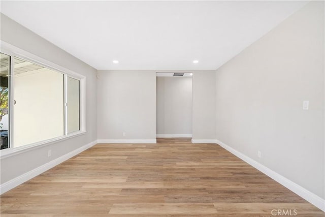 unfurnished room featuring light hardwood / wood-style flooring