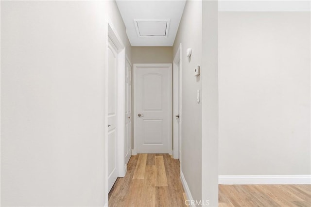 hallway with light hardwood / wood-style floors