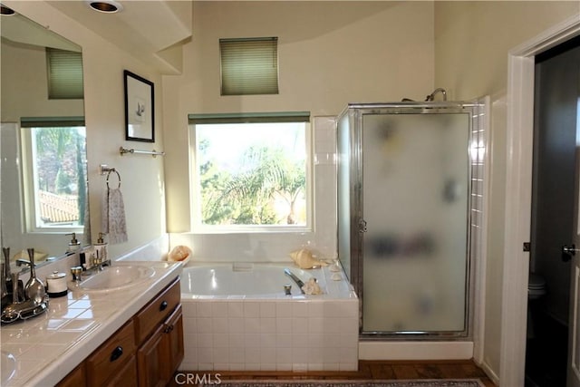 full bathroom featuring plus walk in shower, vanity, and toilet