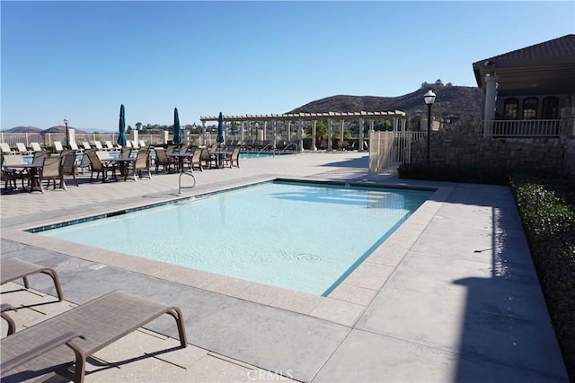 view of swimming pool with a pergola and a patio area