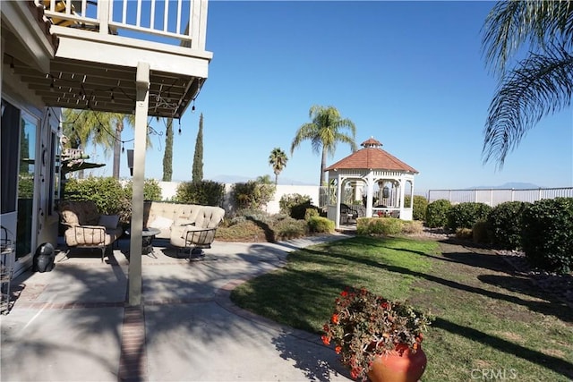 view of yard with an outdoor living space, a gazebo, and a patio