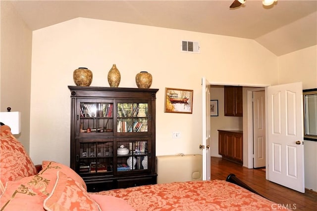 bedroom with lofted ceiling and dark hardwood / wood-style flooring