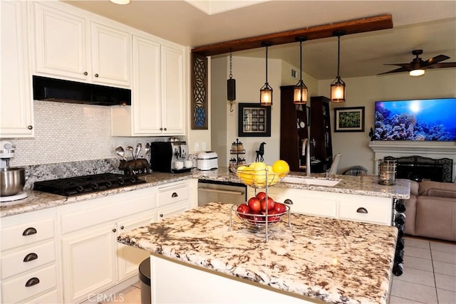 kitchen featuring decorative light fixtures, dishwasher, black gas cooktop, range hood, and decorative backsplash