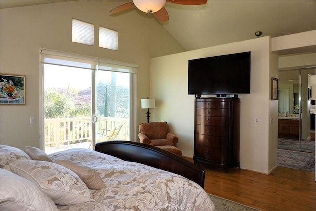 bedroom featuring ensuite bath, wood-type flooring, vaulted ceiling, access to outside, and ceiling fan