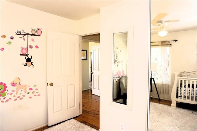 bedroom featuring a nursery area and light hardwood / wood-style floors